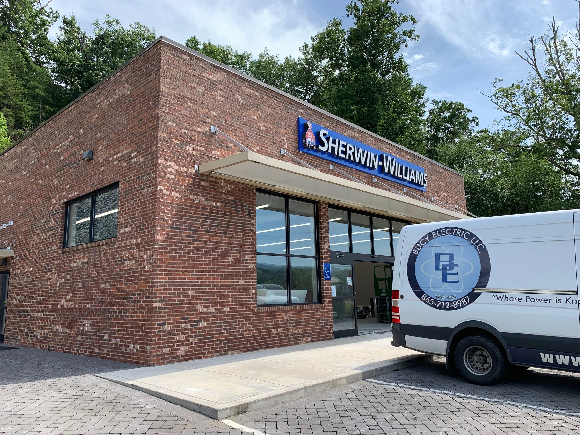 Bucy Electric service van parked at a Sherwin-Williams commercial storefront